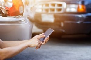 Person calling insurance company after a car accident.