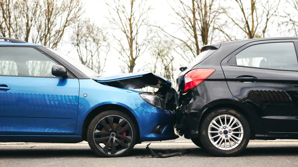 Blue car rear-ending a black car in a collision